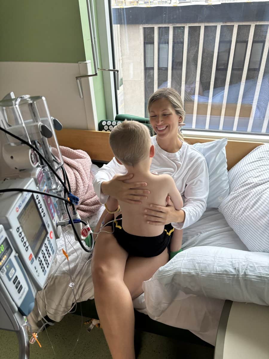 Cody being held by his mother Stacia in his hospital room